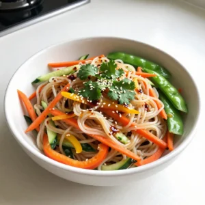 - 8 oz rice noodles - 1 cup shredded carrots - 1 bell pepper (choose red, yellow, or orange) - 1 cucumber - 1 cup snap peas - 3 tablespoons sesame oil - 2 tablespoons soy sauce (or tamari) - 2 tablespoons rice vinegar - 1 tablespoon fresh ginger - 1 tablespoon honey or agave syrup - 1/4 cup sesame seeds - 1/4 cup fresh cilantro - Chopped peanuts or cashews for added texture The main ingredients in this dish create a bright and crunchy salad. The rice noodles serve as the base. They soak up all the flavors well. The carrots add a sweet crunch, while the bell pepper brings a nice color. You can choose any color you like. Cucumbers add a refreshing bite, and snap peas give a sweet crunch. For the dressing, sesame oil is rich and fragrant. It pairs well with soy sauce or tamari for a salty kick. Rice vinegar adds tanginess, while fresh ginger gives a spicy warmth. Honey or agave syrup balances the sharp flavors. For extra fun, you can add garnishes. Sesame seeds add a lovely crunch. Fresh cilantro gives a bright flavor. If you want more texture, sprinkle on some chopped peanuts or cashews. These ingredients make your salad not just tasty but also interesting to eat. {{ingredient_image_2}} To start, fill a large pot with water and bring it to a boil. Once the water is bubbling, add the rice noodles. Cook them according to the package instructions, usually around 4 to 6 minutes. When they are tender, drain the noodles in a colander. Rinse them under cold water to stop the cooking. This helps keep them from getting mushy. Set the noodles aside to drain completely. While the noodles cook, it&rsquo;s time to prep the veggies. First, shred the carrots using a grater. Then, take the bell pepper and slice it into thin strips. For the cucumber, julienne it into matchstick shapes. Finally, trim the ends of the snap peas for that perfect crunch. This colorful mix adds great flavor and texture to your salad. In a small mixing bowl, combine the dressing ingredients. Add 3 tablespoons of sesame oil, 2 tablespoons of soy sauce, and 2 tablespoons of rice vinegar. Next, grate 1 tablespoon of fresh ginger and add that too. For a hint of sweetness, mix in 1 tablespoon of honey or agave syrup. Whisk it all together until well blended. Taste the dressing and adjust it with salt and pepper to suit your liking. Grab a large mixing bowl for this step. Gently mix the cooked noodles with the shredded carrots, sliced bell pepper, julienned cucumber, trimmed snap peas, and sliced green onions. Make sure everything is evenly incorporated. This step builds the base of your salad. Now, it&rsquo;s time to make your salad look amazing! Sprinkle 1/4 cup of sesame seeds and 1/4 cup of chopped cilantro over the top. Give the salad one last gentle toss to spread the garnishes evenly. For serving, use a wide, shallow bowl. This lets the colorful ingredients shine. If you want more crunch, you can add chopped peanuts or cashews on top. Enjoy your fresh and flavorful dish! Rinsing your noodles is key. It stops cooking and keeps them from sticking. This creates a perfect base for your salad. After cooking, drain the noodles and rinse them under cold water. Mix your fresh veggies just before serving. This keeps them crunchy and bright. If you add them too early, they can get soggy. A fresh crunch enhances the overall taste. You can add many veggies to this salad. Try bell peppers, radishes, or even broccoli. They add great color and flavor. For protein, toss in grilled chicken or shrimp. If you want a vegan option, use tofu or chickpeas. If you're gluten-free, use tamari instead of soy sauce. Rice noodles are already gluten-free, making this dish easy for everyone. You can also use spiralized veggies as a fun twist. Pair this salad with proteins like chicken or tofu. They add heartiness and make it a full meal. You can grill or saut&eacute; the protein for extra flavor. For side dishes, consider spring rolls or edamame. They complement the salad well. These options keep your meal light and fresh, perfect for warm days. Pro Tips Fresh Ingredients: Use fresh vegetables for the best flavor and texture. The crunchier the vegetables, the better the salad will taste! Customize Your Noodles: Rice noodles can be substituted with soba or whole wheat noodles for a different flavor and texture. Make Ahead: This salad can be made a few hours in advance. However, wait to add the dressing until just before serving to keep the vegetables crisp. Spice It Up: For an extra kick, add sliced jalape&ntilde;os or a dash of chili oil to the dressing for a spicy twist! {{image_4}} You can switch rice noodles for other types. Try whole grain noodles for a nutty taste. Vegetable noodles add color and flavor. Zucchini or sweet potato noodles work great. They keep your dish fresh and light. Change the dressing for extra zing. Use sesame paste for a rich taste. Peanut butter gives a creamy twist. If you enjoy spice, add chili oil or sriracha. This will kick up the heat and flavor. Use fresh veggies based on the season. Spring brings tender asparagus and snap peas. In summer, add ripe tomatoes or bell peppers. Autumn calls for roasted squash or carrots. Choose what&rsquo;s fresh and tasty in your area! This keeps the salad exciting and full of flavor. To keep your Sesame Ginger Noodle Salad fresh, store it in an airtight container. Make sure to refrigerate the salad right after serving. This helps prevent any spoilage. If you used fresh veggies like cucumber or snap peas, eat them within a couple of days. Their crunch is best when fresh. You should serve this salad cold or at room temperature. If you want to eat it warm, add a little hot water to the dressing. This will help revive the flavors. Try not to heat the noodles, as they can become mushy. Toss everything gently to mix the dressing back in. In the fridge, this salad lasts about three days. Look for any signs of spoilage, like a funky smell or slimy veggies. If you notice either of these, it&rsquo;s best to toss it out. Always trust your senses when checking for freshness! Yes, you can make this salad ahead of time. To keep it fresh, store the noodles, vegetables, and dressing separately. Mix them just before serving. This helps keep the noodles from getting soggy. When stored this way, the salad stays crisp and tasty for up to three days. If you need a soy sauce substitute, try tamari. Tamari is gluten-free and has a similar taste. You can also use coconut aminos for a lighter flavor. For lower sodium, look for low-sodium soy sauce or tamari options. These swaps keep your salad flavorful without the extra salt. Yes, this salad is great for meal prep. Portion it into containers for easy grab-and-go meals. Keep the dressing in a small jar to add later. This way, the salad stays fresh all week. You can prepare enough for lunch or dinner for several days. Absolutely! Adding protein makes the salad more filling. You can use grilled chicken, shrimp, or tofu. Cook the protein ahead and slice it up. Mix in the protein with the noodles and veggies for a balanced meal. It&rsquo;s a tasty way to add nutrition to your dish. This article covered the essentials of making a delicious Sesame Ginger Noodle Salad. You learned about the main ingredients, how to prepare them, and tips for the best texture. Remember to customize your salad with seasonal veggies and proteins. Enjoy experimenting with flavors and garnishes. This salad is healthy, quick, and perfect for meal prep. Keep leftovers fresh in the fridge and enjoy them throughout the week. Now, get cooking and delight in every bite of your new favorite salad!