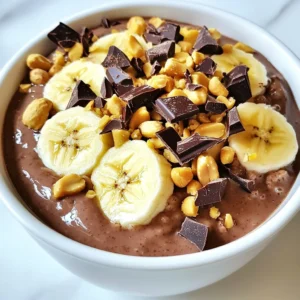 - 1 cup rolled oats - 2 cups almond milk (or any milk of your choice) - 2 tablespoons unsweetened cocoa powder - 3 tablespoons creamy peanut butter - 2 tablespoons maple syrup (adjust based on sweetness preference) - 1 teaspoon pure vanilla extract - A pinch of fine sea salt - Chopped dark chocolate - Banana slices - Chopped peanuts The ingredients for Chocolate Peanut Butter Overnight Oats are simple and easy to find. First, you need rolled oats. They give your oats the right texture and chew. Next, choose almond milk or any milk you like. It adds creaminess to the dish. Unsweetened cocoa powder gives your oats a rich chocolate flavor. Creamy peanut butter brings in that nutty taste we all love. Maple syrup acts as a sweetener, and you can adjust it to your taste. Pure vanilla extract adds a lovely aroma. A pinch of fine sea salt rounds out the flavors nicely. For optional toppings, you can get creative! Chopped dark chocolate adds more chocolate goodness. Fresh banana slices bring in natural sweetness. Chopped peanuts give a nice crunch. You can mix and match these toppings to make your oats even more delightful. {{ingredient_image_2}} In a large bowl, combine 1 cup of rolled oats, 2 tablespoons of cocoa powder, and a pinch of fine sea salt. Stir well until they mix evenly. This step ensures a chocolatey base for your oats. In another bowl, whisk together 2 cups of almond milk, 3 tablespoons of creamy peanut butter, 2 tablespoons of maple syrup, and 1 teaspoon of pure vanilla extract. Mix until smooth and all ingredients blend well. This mixture adds richness and sweetness to the oats. Gradually pour the wet mixture into the dry ingredients. Stir until all oats are coated with the chocolate-peanut butter blend. Once mixed, divide the mixture into two jars or airtight containers. Pack it slightly to reduce air gaps for better soaking. Seal the jars tightly and place them in the fridge. Refrigerate overnight or for at least 4 hours. This soaking time helps the oats absorb all those tasty flavors. In the morning, take the jars out of the fridge. Stir the oats well to mix everything together. If you like a creamier texture, add a splash more almond milk and mix again. Top with chopped dark chocolate, banana slices, and chopped peanuts for extra flavor and crunch. Enjoy this delightful treat! You can change the sweetness of your oats. If you want it sweeter, add more maple syrup. If you like it less sweet, use less. This simple tweak makes a big difference in taste. To make your oats creamier, just add more almond milk. Mixing in a splash more will give your oats a smooth texture. Play around with the milk until you find your perfect creaminess. Serve your oats in clear jars. This makes them look pretty and shows off the layers. You can also drizzle more peanut butter on top for a nice touch. It adds color and makes it even more inviting. Pro Tips Store in Glass Jars: Using glass jars not only looks appealing but also helps in keeping the oats fresh and allows you to see the delicious layers. Experiment with Milk Alternatives: Feel free to substitute almond milk with coconut, oat, or soy milk for different flavor profiles and nutritional benefits. Adjust Sweetness: Customize the level of sweetness by varying the amount of maple syrup or using honey or agave nectar for a different taste. Add Protein: Boost the protein content by mixing in some Greek yogurt or a scoop of your favorite protein powder before refrigerating. {{image_4}} You can switch things up by using different nut butters. Try almond butter or cashew butter for a tasty twist. Flavored protein powders also add a fun kick. Chocolate or vanilla protein powder blends well with the oats, enhancing both taste and nutrition. Experiment with what you love! For a vegan option, simply replace the almond milk with any plant-based milk. Use maple syrup as your sweetener; it&rsquo;s vegan-friendly too. If you&rsquo;re gluten-free, ensure your oats are certified gluten-free. There are many ways to enjoy this treat while sticking to your diet. Seasonal fruits can elevate your oats. In summer, fresh berries like strawberries or blueberries add sweetness. In fall, try diced apples with a sprinkle of cinnamon. These toppings not only look pretty but also boost flavor and nutrition. You can always adapt your toppings to match the season! To keep your Chocolate Peanut Butter Overnight Oats fresh, store them in the fridge. Use airtight jars or containers. This helps lock in moisture and flavor. Make sure to seal them well. If you have toppings, store them separately. This keeps them crunchy and fresh. You can eat these oats cold right out of the fridge. Many people enjoy them this way. If you prefer warm oats, heat them gently in the microwave. Add a splash of almond milk to keep them creamy. Stir well before eating. For the best taste, eat your overnight oats within three days. After that, they may lose flavor and texture. If you notice any off smell or changes, it&rsquo;s best to toss them out. Enjoy your delicious breakfast while it&rsquo;s fresh! Yes, you can easily make this recipe vegan. To do this, swap the creamy peanut butter for any nut or seed butter. Use maple syrup as your sweetener, which is plant-based. For milk, choose almond milk, oat milk, or soy milk. Each of these options keeps the oats creamy and tasty. Overnight oats stay good in the fridge for up to five days. Store them in airtight containers to keep them fresh. If you add fresh fruit, eat them within a day or two. The oats might become softer over time, but they still taste great. You can use quick oats, but the texture and flavor will change. Quick oats soak up liquid faster, making the mixture creamier. However, they can become mushy if left too long. Rolled oats provide a chewier bite and keep their shape better. You learned how to make tasty overnight oats with simple ingredients and steps. We covered essential items like rolled oats, cocoa powder, and peanut butter. You saw tips for added flavor and how to store leftovers for freshness. Remember, you can switch up toppings and variations to match your taste. These oats will keep you fueled and satisfied. Enjoy creating your own delicious and healthy breakfast!